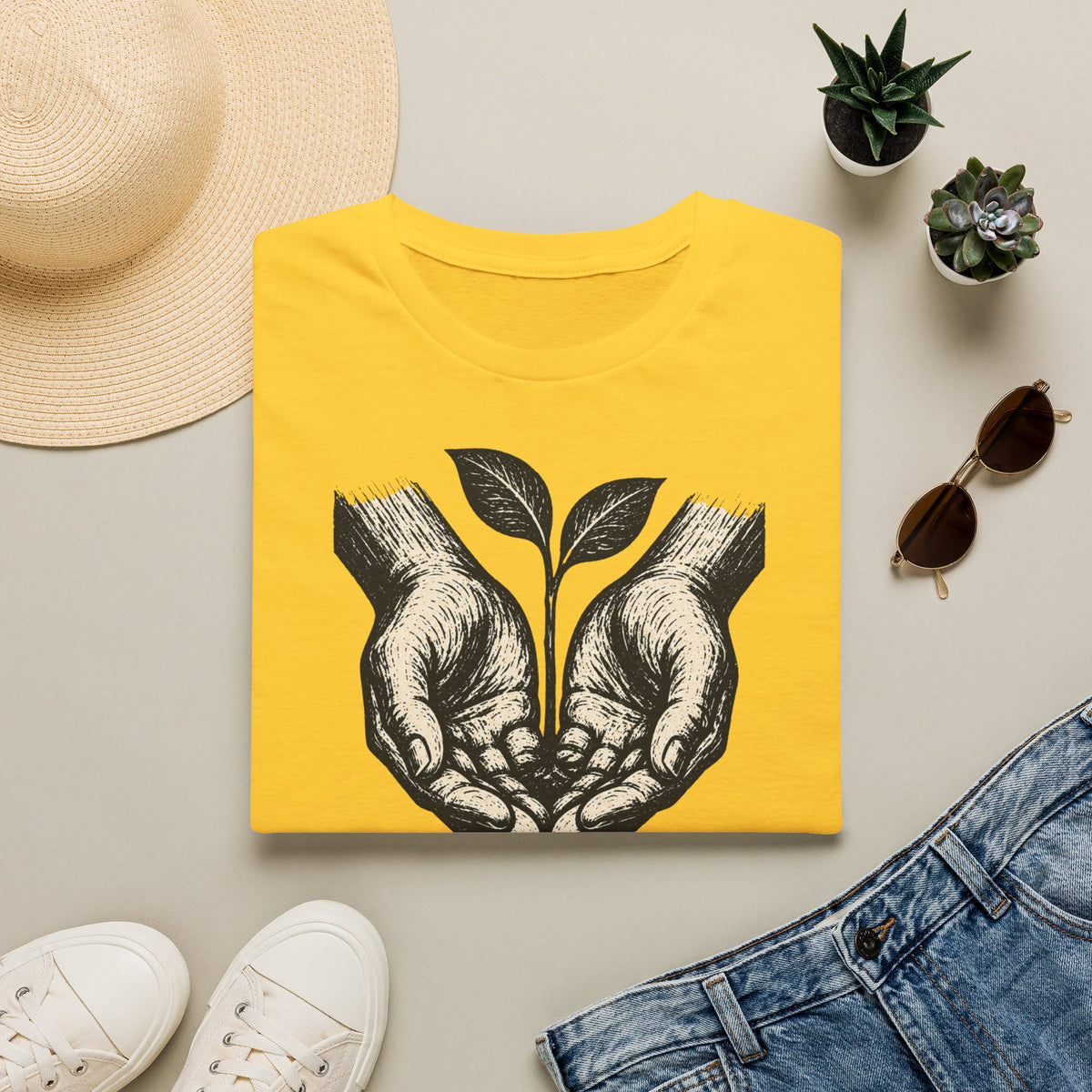 T-shirt — « Entre de bonnes mains » — Illustration graphique de mains tenant une jeune pousse