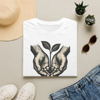 T-shirt — « Entre de bonnes mains » — Illustration graphique de mains tenant une jeune pousse